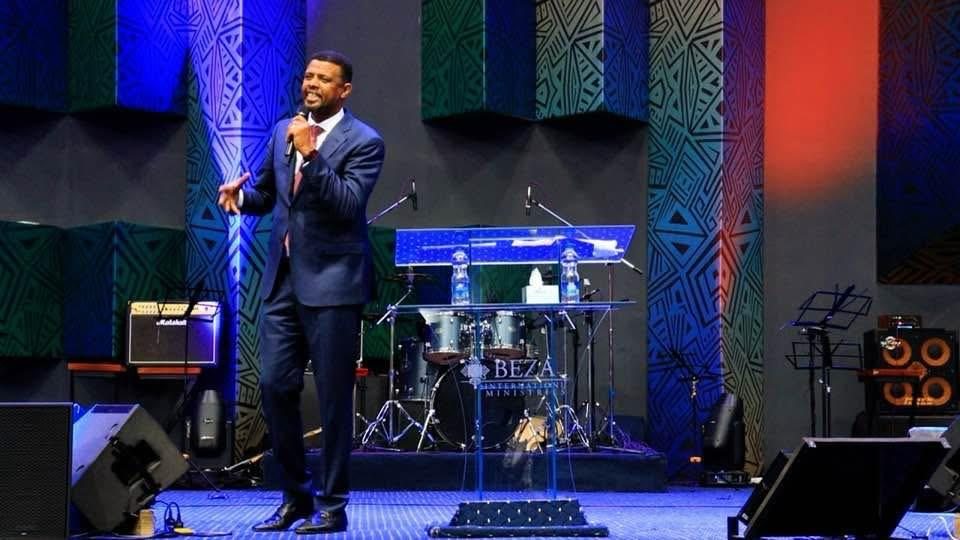 A participant holding a microphone on a church stage.